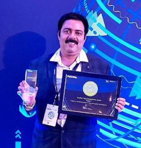 Picture of Anand Rajagopalan holding trophy and certificate